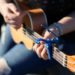 riley playing ukulele with a capo on the fourth fret